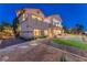 Two-story home with back patio, manicured lawn, desert landscaping and luxurious design at 743 N Orleans St, Henderson, NV 89015