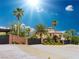Stunning two-story home with mature palms, secure gates, and beautiful desert landscaping at 743 N Orleans St, Henderson, NV 89015