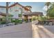 Stunning stucco home featuring mature landscaping and a porte cochere on a concrete driveway at 743 N Orleans St, Henderson, NV 89015