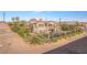 Aerial view of tan stucco house with balcony and desert landscaping surrounded by wrought iron fence at 743 N Orleans St, Henderson, NV 89015