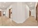 Bright hallway featuring wood floors, recessed lighting, and paneled wood doors at 743 N Orleans St, Henderson, NV 89015