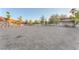 Large horse property featuring a stone retaining wall, metal shed, and white fencing at 743 N Orleans St, Henderson, NV 89015