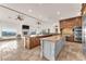 Open kitchen and living area with a fireplace, granite countertops, and modern appliances at 743 N Orleans St, Henderson, NV 89015