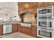 Gourmet kitchen features stainless steel appliances, custom cabinets, and granite countertops at 743 N Orleans St, Henderson, NV 89015