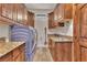 Well-equipped laundry room boasts granite countertops, sink and wood cabinets above high end washer and dryer at 743 N Orleans St, Henderson, NV 89015