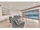 Spacious living room with stylish seating and a large sliding glass door with outdoor access at 743 N Orleans St, Henderson, NV 89015