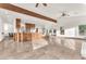 Open concept living area with stone floors, high ceilings, and exposed wood beam at 743 N Orleans St, Henderson, NV 89015