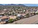 An aerial view of a residential neighborhood with palm trees, desert landscaping, and mountain views at 818 Grape Vine Ave, Henderson, NV 89002