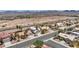 An aerial view of a residential neighborhood, showing new construction, palm trees, desert landscaping, and mountain views at 818 Grape Vine Ave, Henderson, NV 89002