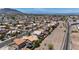 An aerial view of a residential neighborhood, train tracks, desert landscaping, and mountain views at 818 Grape Vine Ave, Henderson, NV 89002