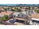 Aerial view of the home featuring a backyard with a trampoline, covered patio, and desert landscaping at 818 Grape Vine Ave, Henderson, NV 89002