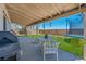 Covered backyard patio with outdoor seating, a grill, and a trampoline at 818 Grape Vine Ave, Henderson, NV 89002