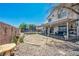 Features a spacious backyard, trampoline, patio with seating and lovely desert landscaping at 818 Grape Vine Ave, Henderson, NV 89002