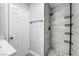 Bathroom featuring modern tile, black fixtures, and a convenient corner storage system at 818 Grape Vine Ave, Henderson, NV 89002