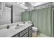 Bathroom featuring a mirrored wall, white countertops, and a dark gray vanity at 818 Grape Vine Ave, Henderson, NV 89002