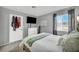 Bedroom with gray walls, natural light, and a TV mounted above a white dresser at 818 Grape Vine Ave, Henderson, NV 89002
