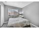 Bright bedroom with a cozy bed and a large window with blinds at 818 Grape Vine Ave, Henderson, NV 89002