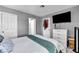Bedroom with gray walls, white trim, and a TV mounted above a white dresser at 818 Grape Vine Ave, Henderson, NV 89002
