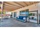 Covered patio includes comfortable seating and a table, perfect for outdoor relaxation and dining at 818 Grape Vine Ave, Henderson, NV 89002