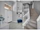 Inviting entryway with high ceilings, tile flooring, decorative niches, and a staircase leading to the upper level at 818 Grape Vine Ave, Henderson, NV 89002