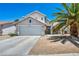 Inviting two-story home featuring a garage, beautiful landscaping, and well-maintained exterior at 818 Grape Vine Ave, Henderson, NV 89002
