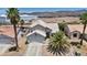 Charming two-story home with desert landscaping, palm trees, and a tile roof at 818 Grape Vine Ave, Henderson, NV 89002