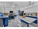Bright kitchen showcases a large island, modern appliances, white countertops, and stylish cabinetry at 818 Grape Vine Ave, Henderson, NV 89002