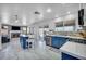 Bright kitchen features a center island, stainless steel appliances, and views to the living room fireplace at 818 Grape Vine Ave, Henderson, NV 89002