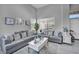 Comfortable living room with plenty of seating, decor, and natural light at 818 Grape Vine Ave, Henderson, NV 89002