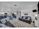 Open-concept living room with kitchen view boasts a fireplace and plush sofas at 818 Grape Vine Ave, Henderson, NV 89002