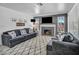Cozy living room with a modern fireplace, a large TV, and plush seating at 818 Grape Vine Ave, Henderson, NV 89002