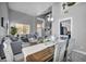 Bright dining and living area featuring stylish seating, modern light fixtures, and decor at 818 Grape Vine Ave, Henderson, NV 89002