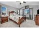 Cozy main bedroom with a king-sized bed, ceiling fan, and large windows for plenty of natural light at 818 Grape Vine Ave, Henderson, NV 89002