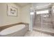 Bright bathroom with soaking tub and glass enclosed shower at 8565 Silver Coast St, Las Vegas, NV 89139