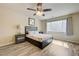 Bedroom featuring ceiling fan, wood floors, and natural light from the window at 8565 Silver Coast St, Las Vegas, NV 89139