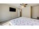 Cozy bedroom with ceiling fan, television, and modern color palette at 8565 Silver Coast St, Las Vegas, NV 89139