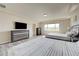 Well-lit bedroom with two beds, neutral walls and plank flooring at 8565 Silver Coast St, Las Vegas, NV 89139