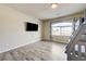 Bedroom with a bunk bed, large window, television and light wood-look flooring at 8565 Silver Coast St, Las Vegas, NV 89139