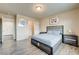 Bedroom featuring a bed, side tables, closet and light wood-look floors at 8565 Silver Coast St, Las Vegas, NV 89139