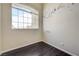 Bright bedroom with dark floors, a large window, and decorative wall art at 8565 Silver Coast St, Las Vegas, NV 89139
