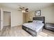 Comfortable bedroom featuring neutral walls, ceiling fan, and wood-look floors at 8565 Silver Coast St, Las Vegas, NV 89139