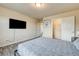 Bedroom featuring a bed, closet, television and light wood-look floors at 8565 Silver Coast St, Las Vegas, NV 89139