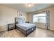 Bedroom featuring a bed, side tables, light wood-look floors and large window at 8565 Silver Coast St, Las Vegas, NV 89139