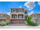 Two-story home featuring stone accents, a balcony, and a three-car garage at 8565 Silver Coast St, Las Vegas, NV 89139