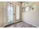 Foyer with decorative glass front door and wood-look flooring at 8565 Silver Coast St, Las Vegas, NV 89139