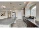 Open kitchen features granite countertops, stainless steel appliances, and modern pendant lighting at 8565 Silver Coast St, Las Vegas, NV 89139