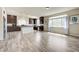 Open kitchen boasts granite countertops, stainless appliances, and a large island, with wood-look floors and plentiful natural light at 8565 Silver Coast St, Las Vegas, NV 89139
