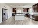 Well-equipped kitchen boasts granite countertops, stainless steel appliances, dark cabinetry and a large center island at 8565 Silver Coast St, Las Vegas, NV 89139