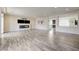 Spacious living area with wood-look floors and fireplace flowing into the open-concept kitchen at 8565 Silver Coast St, Las Vegas, NV 89139