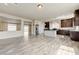Open-concept living area with wood-look floors, neutral walls, and seamless flow to the kitchen for modern living at 8565 Silver Coast St, Las Vegas, NV 89139